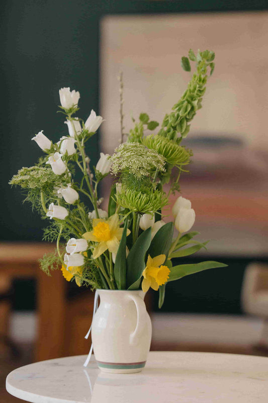 Deluxe flower subscription bouquet with daffodils, tulips, and Queen Anne's lace in a ceramic pitcher – Kvetka Flower